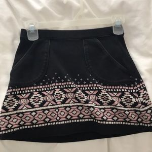 A black with Aztec print mini skirt.
